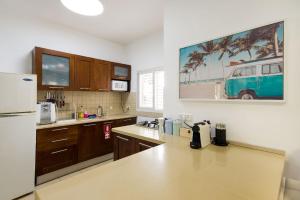 a kitchen with a refrigerator and a counter top at Yagen boutique apartments in Haifa