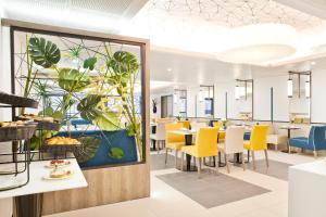 a dining room with a painting of plants at Residhome Marseille in Marseille