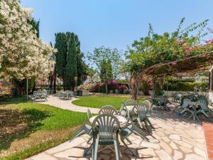 a group of chairs and tables in a park at Apartment in Mont-roig near Sea Beach in Montroig