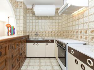 a kitchen with a sink and a stove at Apartment in Mont-roig near Sea Beach in Montroig