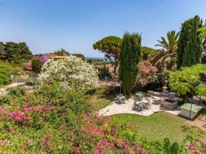 a garden with pink and white flowers and trees at Apartment in Mont-roig near Sea Beach in Montroig +32 photos