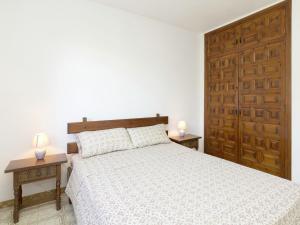 a bedroom with a bed with two tables and two lamps at Apartment in Mont-roig near Sea Beach in Montroig