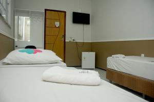 Ένα ή περισσότερα κρεβάτια σε δωμάτιο στο Pousada Moda New