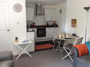 Il comprend une cuisine et un salon avec une table et des chaises. dans l'établissement River Walk, à Lyme Regis