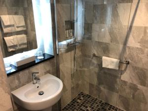 a bathroom with a sink and a shower at The Inn at Dromoland in Newmarket on Fergus