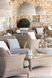 a room with many wicker chairs and a table at Saint Andrea Seaside Resort - Adults Only in Naousa