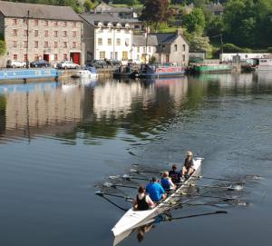 a group of people in boats in the water at Waterside Guesthouse in Graiguenamanagh