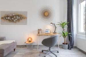 a bedroom with a desk and a chair and a mirror at SLEEP IN MULHOUSE in Mulhouse