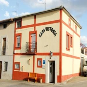 a building with a sign on the side of it at Casa Victoria in Cirueña