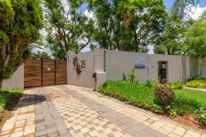 a house with a fence and a driveway at 25 On Chrisoliet in Johannesburg