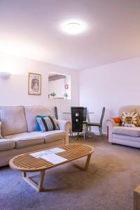 a living room with two couches and a coffee table at Stylish modern Mews house in central St Leonards in Hastings