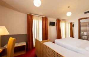 A bed or beds in a room at Accademia Hotel