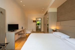 A bed or beds in a room at Accademia Hotel