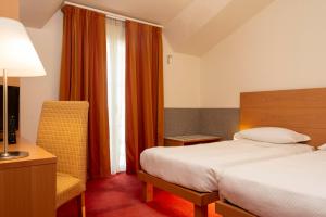 A bed or beds in a room at Accademia Hotel