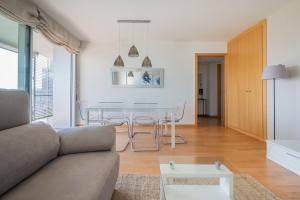 a living room with a couch and a table at Rent Top Apartments Forum in Barcelona