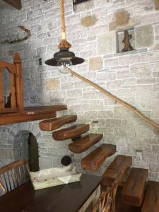 a stone wall with a staircase in a room at Artsistas Houses in Aristi