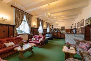 a living room with red furniture and green carpet at Hostel Dakura in Prague