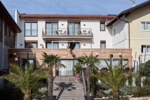 a house with palm trees in front of it at Hotel Gasthof-Strasser in Tumeltsham