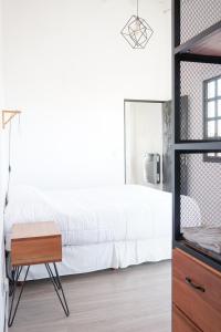a bedroom with a white bed and a table at Departamento Aeropuerto Circunvalacion Kempes Quorum -cambio oficial- in Córdoba