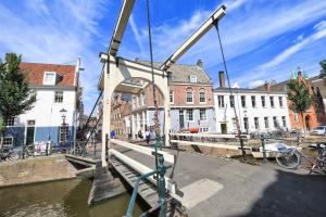 a crane lifting a bridge over a canal at The Hotel Apartments in the Center of Amsterdam in Amsterdam