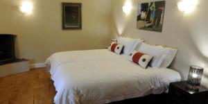 a bedroom with a bed with white sheets and pillows at 59 on Central in Johannesburg