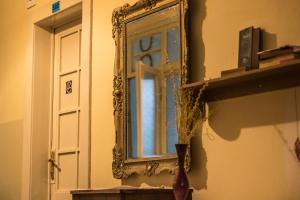 a room with a window and a mirror at Hostel Dakura in Prague