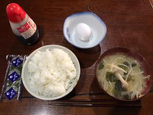a table with a bowl of rice and a bowl of soup at Guesthouse Nishiki in Chichibu