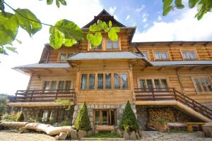 a large wooden house with a gambrel at Pod Zielonym Bykiem in Witów