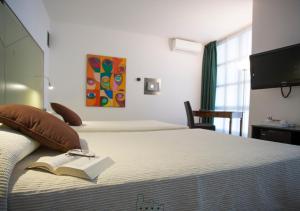 Postel nebo postele na pokoji v ubytování Hotel Buonconsiglio