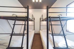 Ένα ή περισσότερα κρεβάτια σε δωμάτιο στο Guesthouse Nibutani Yanto