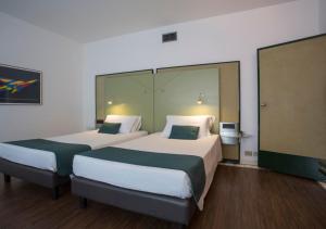 Postel nebo postele na pokoji v ubytování Hotel Buonconsiglio