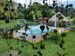 a swimming pool in the yard of a house at Finca Hotel La Esmeralda Casa 2 in Calarcá