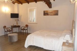 a bedroom with a bed and a table and chairs at Antico Podere Emilia in Reggio Emilia