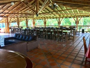 a dining room with tables and chairs in a pavilion at Finca Hotel La Esmeralda Casa 1 in Calarcá