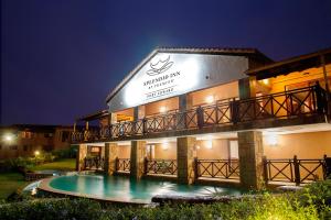 a hotel with a swimming pool at night at Premier Splendid Inn Port Edward in Port Edward