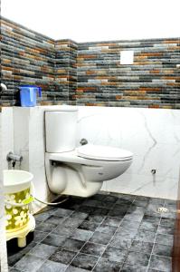 a bathroom with a white toilet in a room at Hotel Kirandeep, Agra in Agra