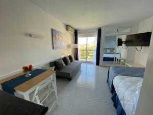 un salon avec un lit et un canapé dans l'établissement MiNERVA, à Benalmádena