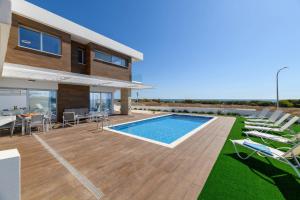 a villa with a swimming pool and a house at Infinity View Villa in Ayia Napa
