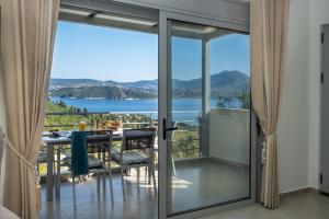 vistas desde una habitación con puertas correderas de cristal en Thealos Village, en Ligia