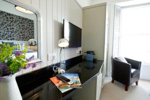 a room with a desk with a computer and a mirror at 27 The Terrace in St Ives