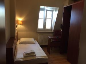 a bedroom with a bed and a window at Hotel Hamburg Altona in Hamburg