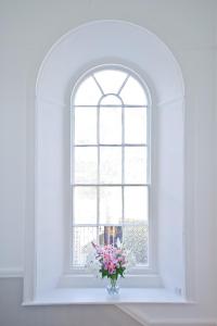 a vase of flowers sitting in front of a window at 27 The Terrace in St Ives