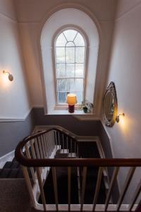 a spiral staircase with a window and a stair case at 27 The Terrace in St Ives