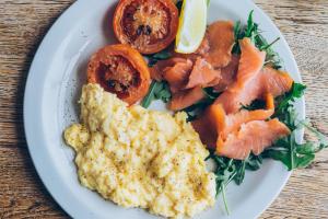 a plate of food with eggs and tomatoes on a table at 27 The Terrace in St Ives