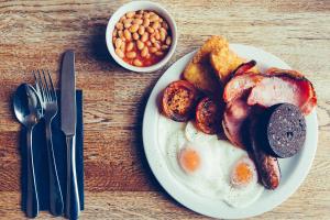 a plate of breakfast food with eggs potatoes and beans at 27 The Terrace in St Ives