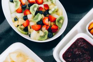 a bowl of fruit with strawberries and blueberries on a table at 27 The Terrace in St Ives