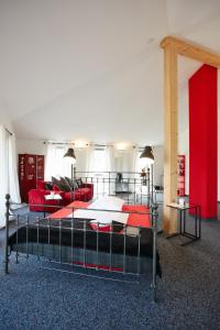 a bedroom with a bed with red pillows on it at Gästehaus am Landgut in Schönwalde