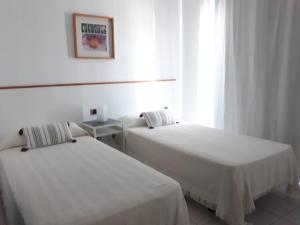 Łóżko lub łóżka w pokoju w obiekcie Villa Suculenta
