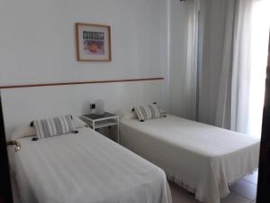 Łóżko lub łóżka w pokoju w obiekcie Villa Suculenta