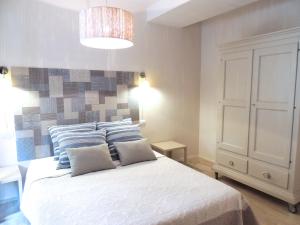 a bedroom with a bed with two pillows on it at Sogno Azzurro - ArgonautiVacanze in Porto Azzurro
